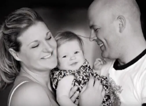 Jamie and Shanda holding baby Hannah — black-and-white portrait.